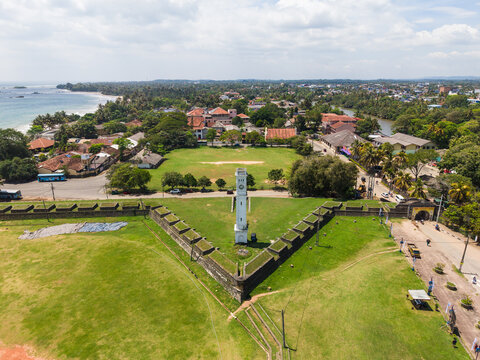 Aerial view of the historic star-shaped Matara Fort and its white clock tower surrounded by green lawns and the coastal town in Matara, Southern Province, Sri Lanka.