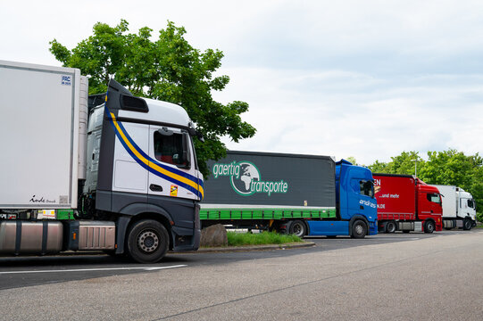 Row of trucks parking at rest stop on german highway Autobahn near Karlsruhe, Germany, driver taking a break for traffic safety