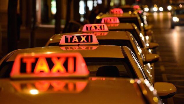 Perspective view of a long row of glowing red taxi signs on yellow cab rooftops lined up bumper to bumper on an urban street at night, receding into bokeh city lights.