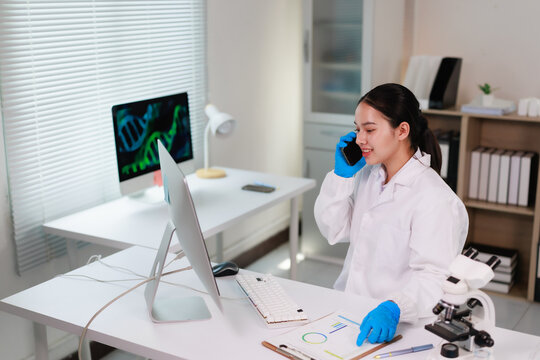 Female scientist doctor in laboratory office using smartphone for patient consultation, discussing research data, biotechnology breakthroughs, and genomics results
