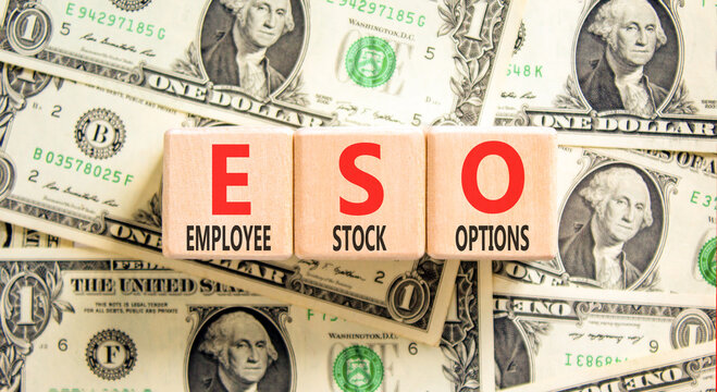 ESO employee stock options symbol. Concept words ESO employee stock options on beautiful wooden blocks. Beautiful dollar bills background. Business ESO employee stock options concept. Copy space.