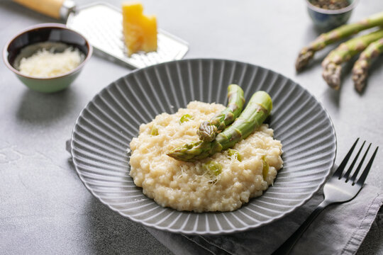 Risotto with asparagus in ceramic plate. Italian Cuisine.