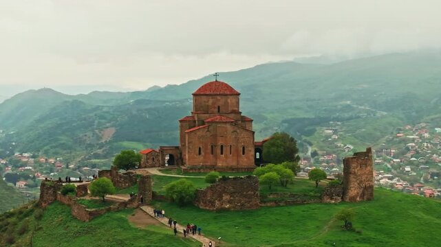 Detailed aerial study of the ancient Vardzia cave monastery and its surrounding river valley. Showcasing Georgia's unique medieval rock-cut architecture and religious heritage.