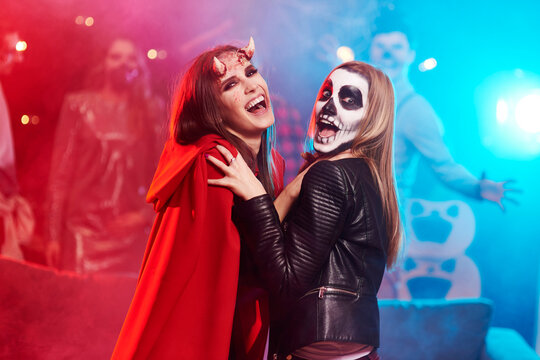 Women in creepy costumes dancing at Halloween party
