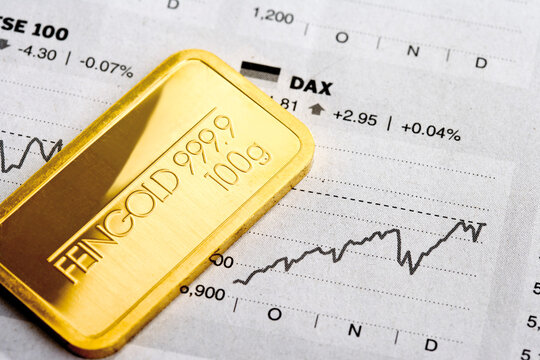 Gold bar and financial newspaper