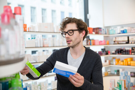 Man comparing products in a pharmacy
