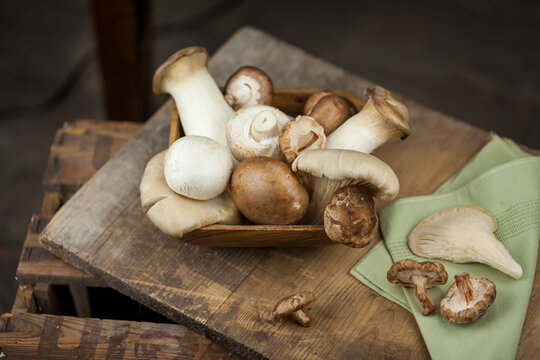 Wooden bowl of different mushrooms