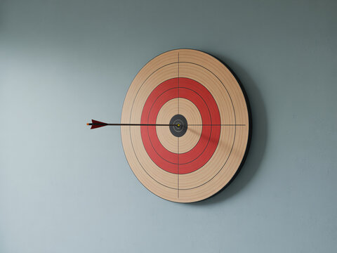 Archery target with arrow hitting bullseye on wall for business concept and goal achievement