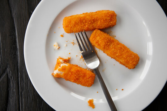 Fish fingers on plate, elevated view