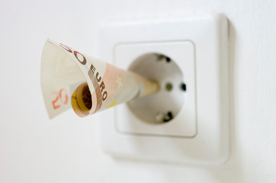 50 euro note kept into electrical socket, close up
