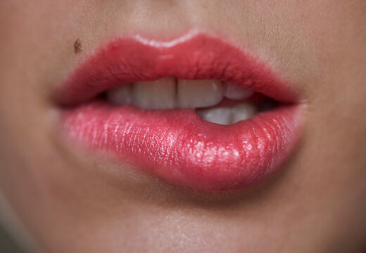 Close-up of woman biting on her lip