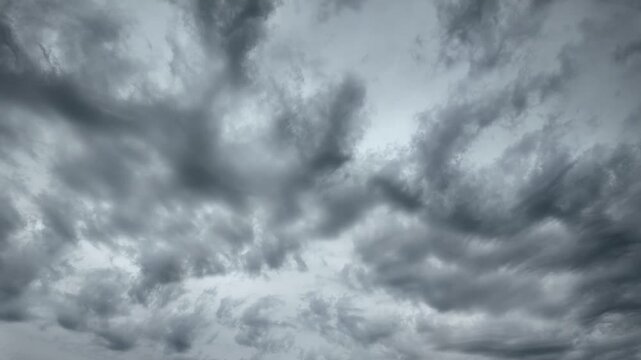 Black and gray clouds cover the sky. Clouds are approaching before a storm and rain with a thunderstorm