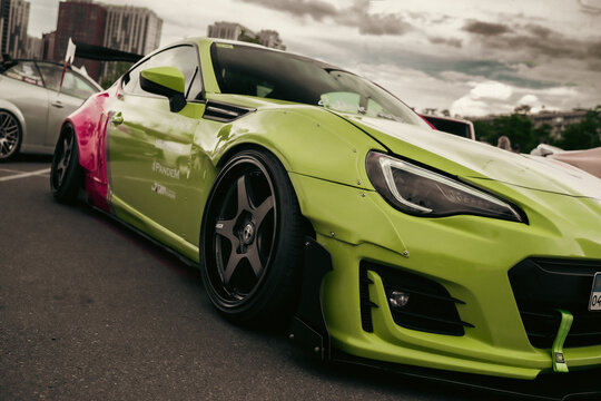 Ukraine, Kyiv - 20 October 2023. Kyiv Car Fest. Modified striking two-tone pink and lime green job Subaru BRZ