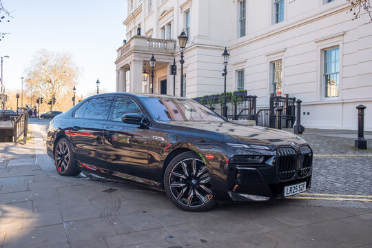 LONDON - KNIGHTSBRIDGE - Black BMW M760e luxury car parked Brompton Road classical buildings