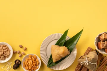 Traditional Chinese sticky rice dumpling Zongzi with side ingredients. © RomixImage