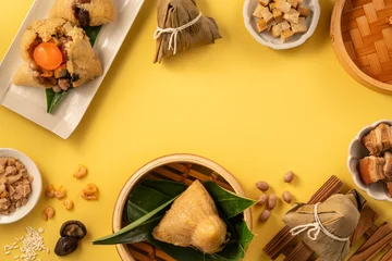 Traditional Chinese sticky rice dumpling Zongzi with side ingredients. © RomixImage