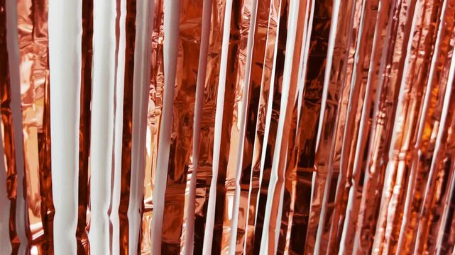 Shiny red gold tinsel curtain swaying gently, creating a beautiful play of light and shadow, an elegant and festive decoration isolated on a clean white background, perfect for any celebration