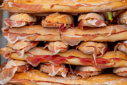 Large pile of Spanish serrano ham sandwiches The Concept of traditional food and gastronomy