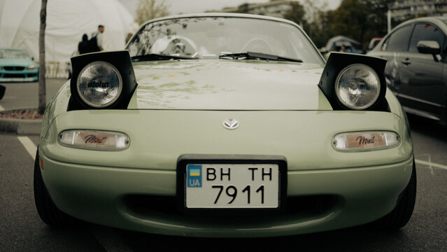 Kyiv, Ukraine - October 20, 2023. Green Mazda MX-5 Miata roadster with raised pop-up headlights displayed at Kyiv Car Fest, an automotive event featuring classic, custom and enthusiast vehicles in Kyi