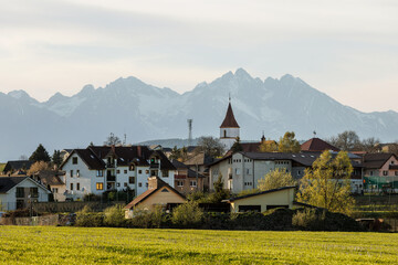 European village houses with snowy High Tatras background © 9parusnikov