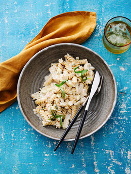 This dish features rotini pasta coated in a creamy sauce with fresh herbs. It's ideal for menu design, food blogs, and meal prep marketing