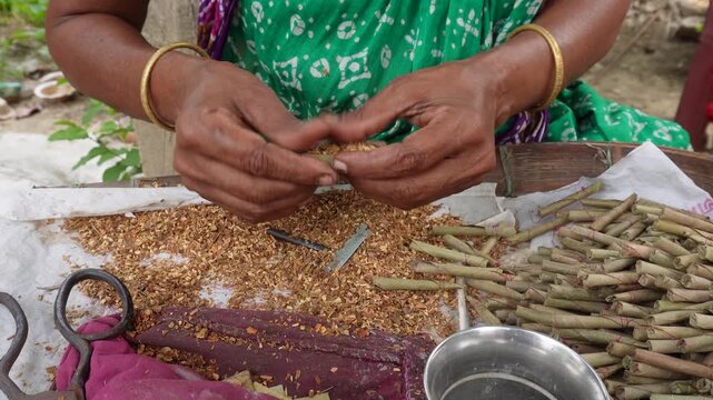 Women hand rolling traditional beedis