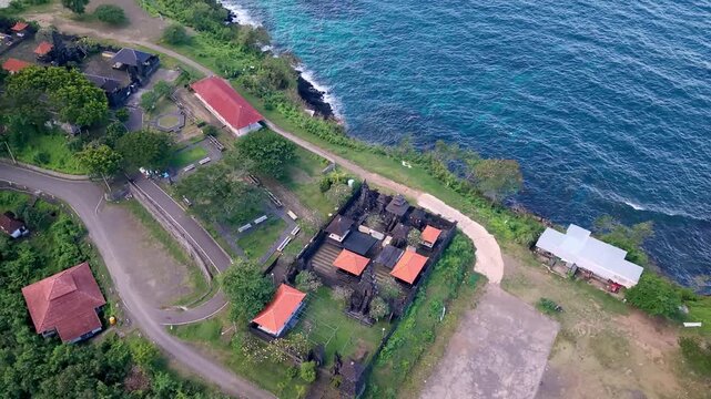 Aerial view of Silayukti Temple complex on a coastal cliff in Padangbai, Bali