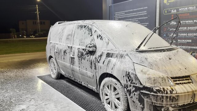 Minivan covered in foam at self-service car wash