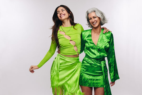 Mother and daughter laughing with arms around each other