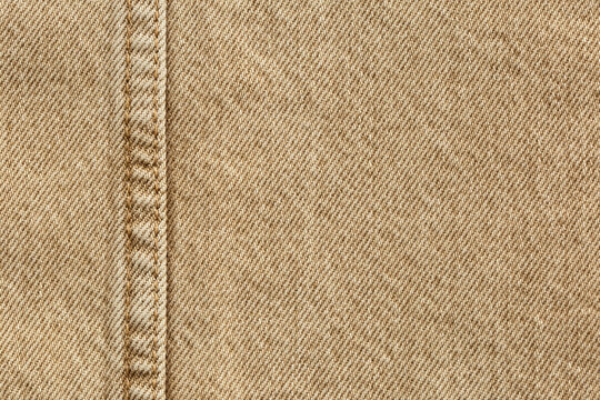 beige jeans denim fabric texture background with seam