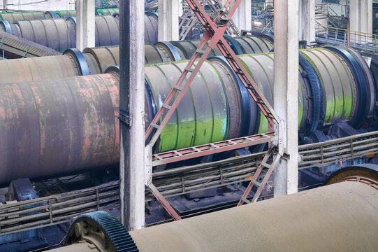Drum debarker in operation at a wood processing facility during daytime hours
