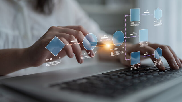 Hands Typing on a Laptop with Flowchart Elements Illustrating Data Processing and Input Modelling Concepts in a Modern Office Environment Quark.