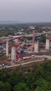 Vertical Aerial infrastructure scene of Elevated rail bridge megaproject during construction for Thailand&rsquo;s future high-speed train network