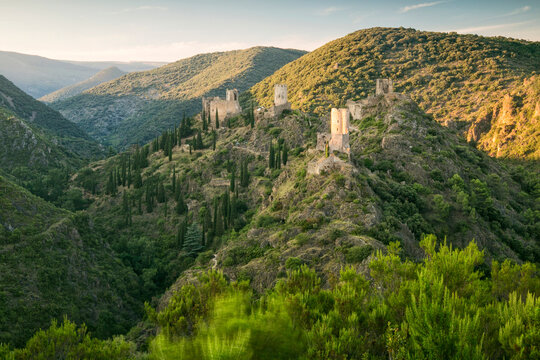 Historic medieval ruins perched on rugged hills invite nature tourism and exploration within the scenic mountain landscape of Four Lastours castle, Languedoc-Roussillon, France.