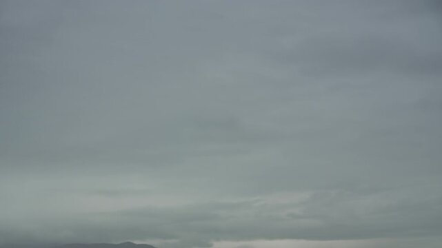 Timelapse moving thunderclouds before storm, panning view of the mountains. Stormy weather, melancholy, depression. City life timelapse
