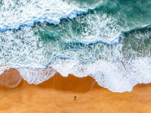 aerial view of waves on the beach