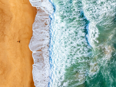 aerial view of waves on the beach