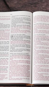 Christian holy bible book on wooden table. Vertical video. Scripture study concept.