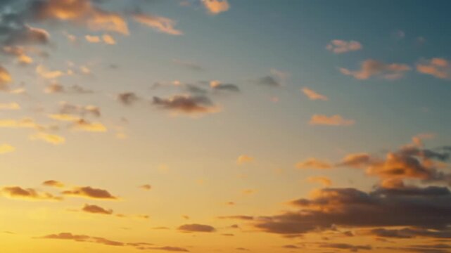 Ultra-wide cinematic video of ethereal clouds drifting, morphing across an expansive sky at golden hour, warm golden and fiery orange hues, soft volumetric light. Concept of hope and new beginnings