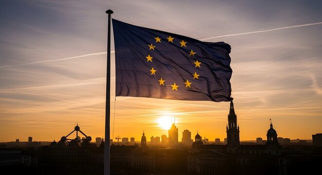 European Union flag waving over Brussels city skyline at golden sunset