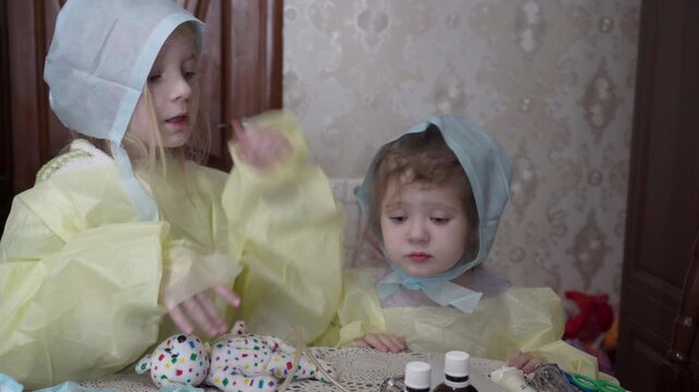 Children are playing the game "Hospital" at home during winter days.
