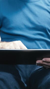Male person on floor with a tablet computer in hands