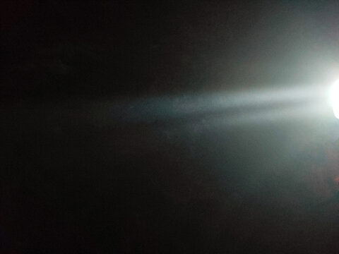 Abstract beam of light in the dark, breaking through the darkness. Effective contrast of light and shadow, mystical or fantastic atmosphere. Concept of hope, mystery, space.
