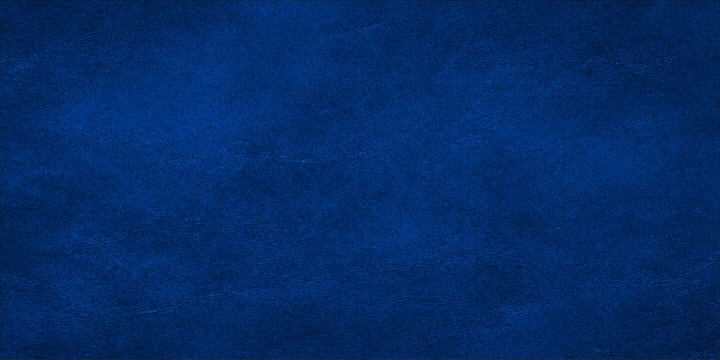 This vintage blue denim paper texture features a rough grunge background with a dark canvas pattern and a worn textile surface design
