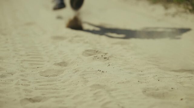 Runner In Sneakers Jogging On Dusty Sandy Road. Athlete Training Outdoors. Cardio Workout