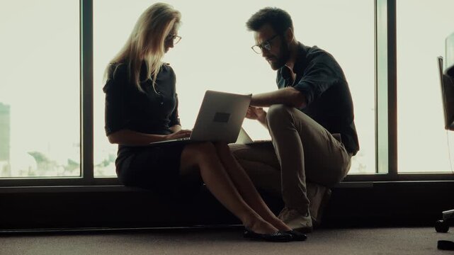 Corporate Colleagues Sharing Ideas Near Office Window. Professional Specialists Teamwork