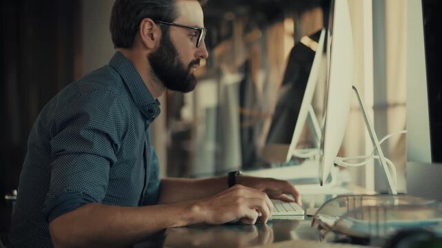 Businessman Working On Computer In Office. Focused Specialist IT Typing on Keyboard Looking At Screen monitor