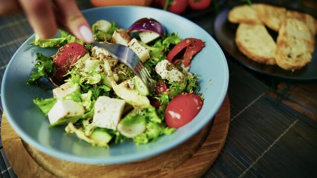 Mixing Fresh Greek Salad With Feta Cheese Vegetables. Eating Healthy Vegetarian Meal 