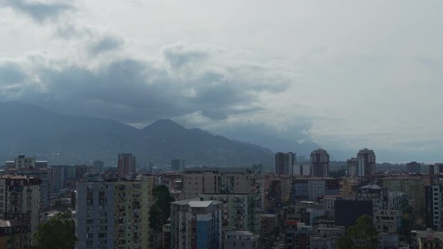 Panning view climate change, storm warning, environmental protection. Storm clouds are scudding over a city at the foot of the Caucasus Mountains timelapse. Problem of urban air pollution