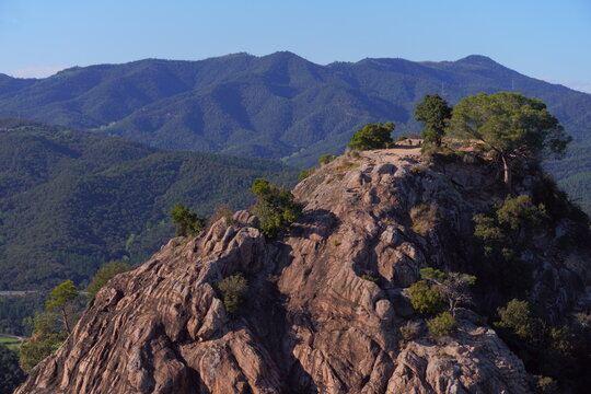 Rocky mountain landscape. Tur&oacute; del Vent at the right with green mountains in the background. Santa Coloma de Farners, Catalonia.